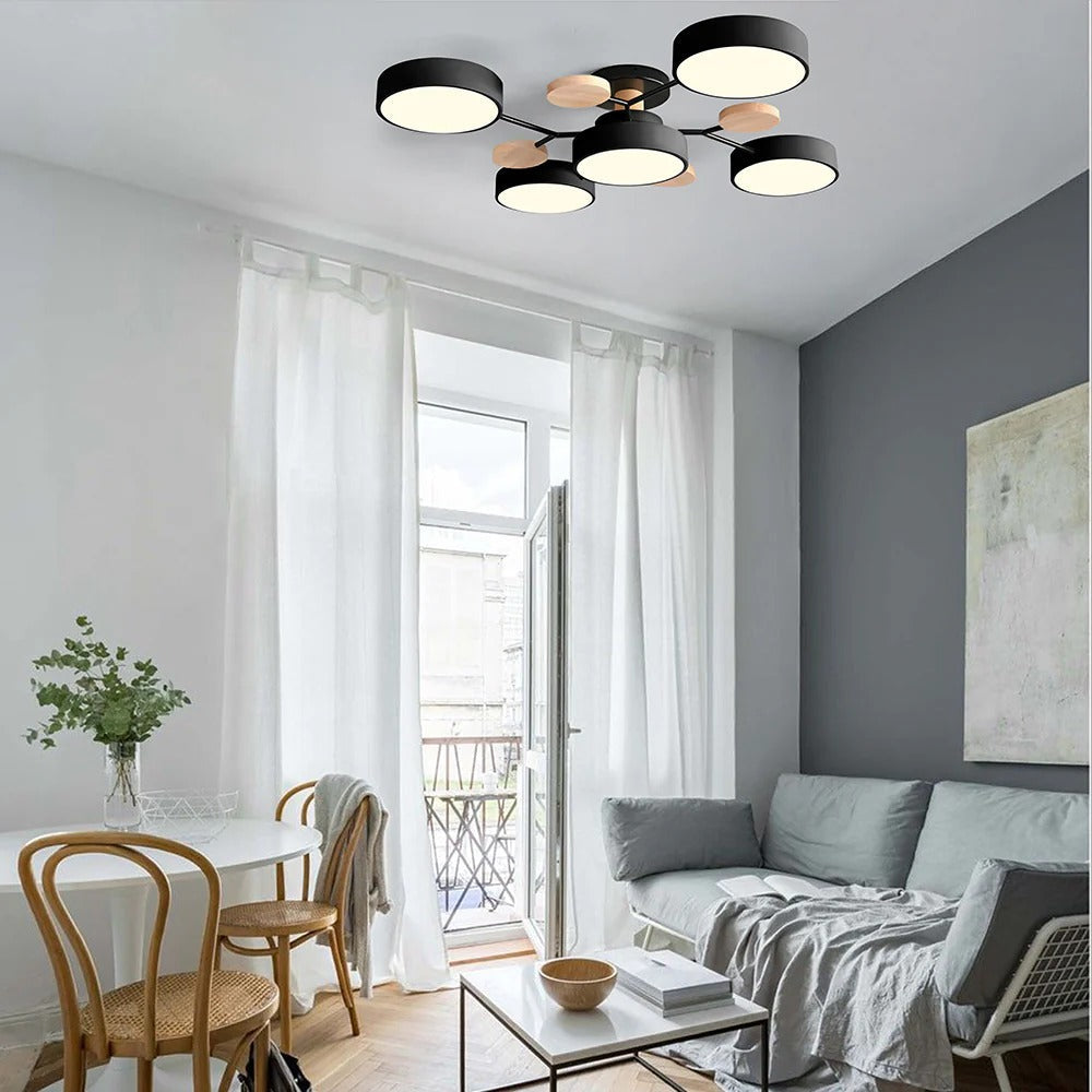 Black lasve 5-light Nordic LED fixture spreading even, anti-glare light across a dining space