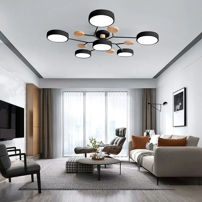 Black 6-light Nordic lasve branch fixture perfectly illuminating a contemporary living room seating area