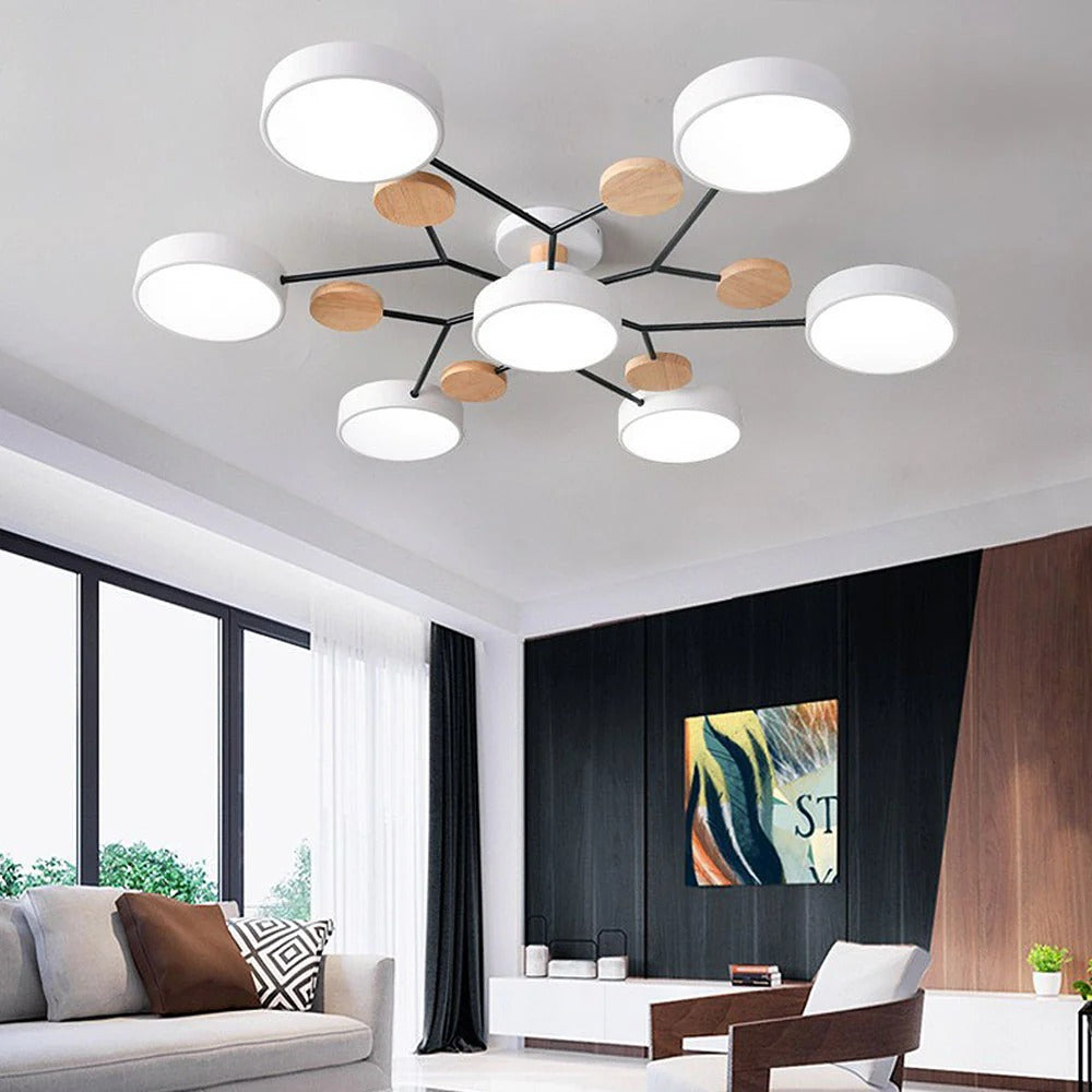 White lasve 7-light Nordic multi-arm lamp casting bright, shadow-free light in a modern lounge
