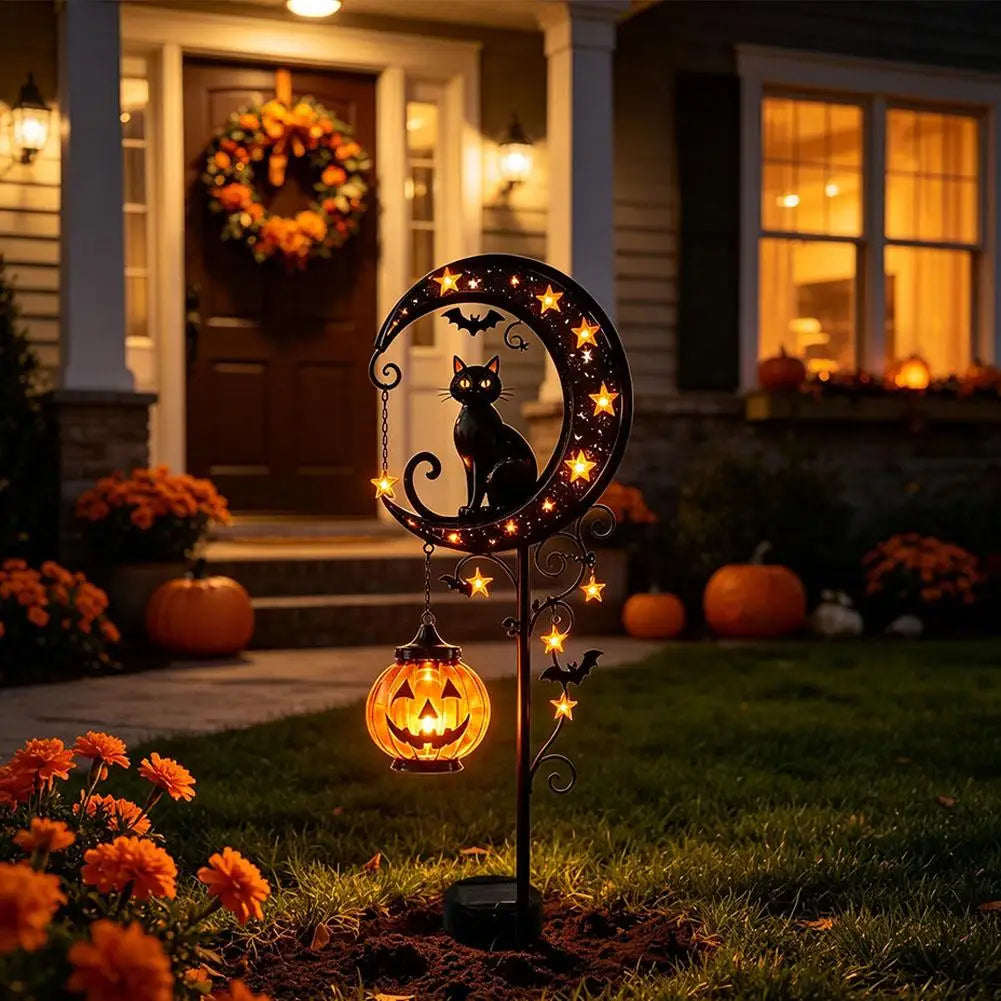 Lawnlurk solar black cat and pumpkin moon garden stake light in a flower bed