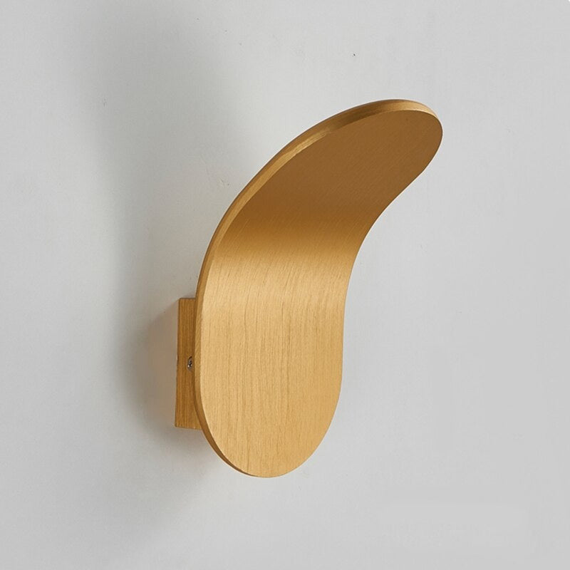 Side view of the elegant gold modern shield lexi wall light showing its curved silhouette