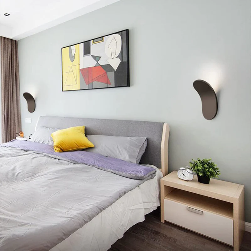 Pair of lexi brown curved LED wall sconces framing a bed in a modern minimalist bedroom