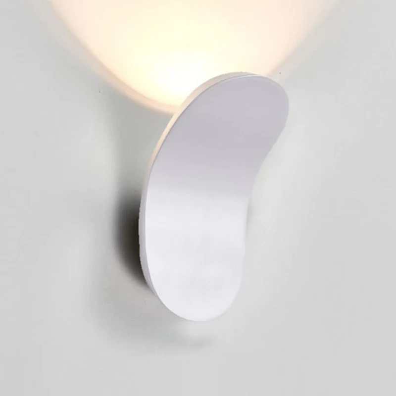 Modern lexi white curved LED wall sconce highlighting its glare-free indirect halo lighting effect