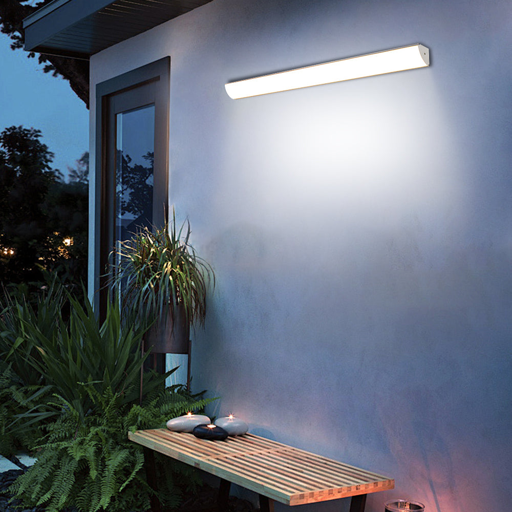 Linear garden wall lighting providing ambient illumination over an outdoor seating area