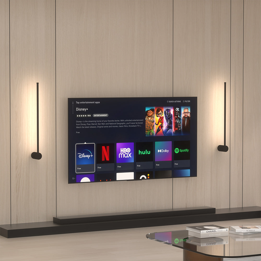 Two modern linear LED wall sconces mounted vertically to beautifully frame a living room television