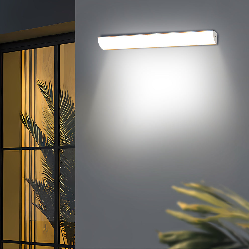 Bright linear LED wall lamp highlighting the exterior near modern glass sliding doors