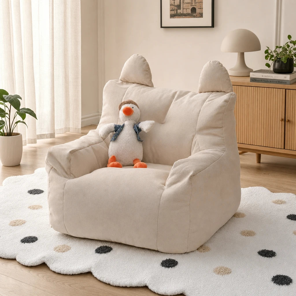 Beige Fleece Lydel cartoon bear kids bean bag armchair with a duck plush toy in a modern minimalist room