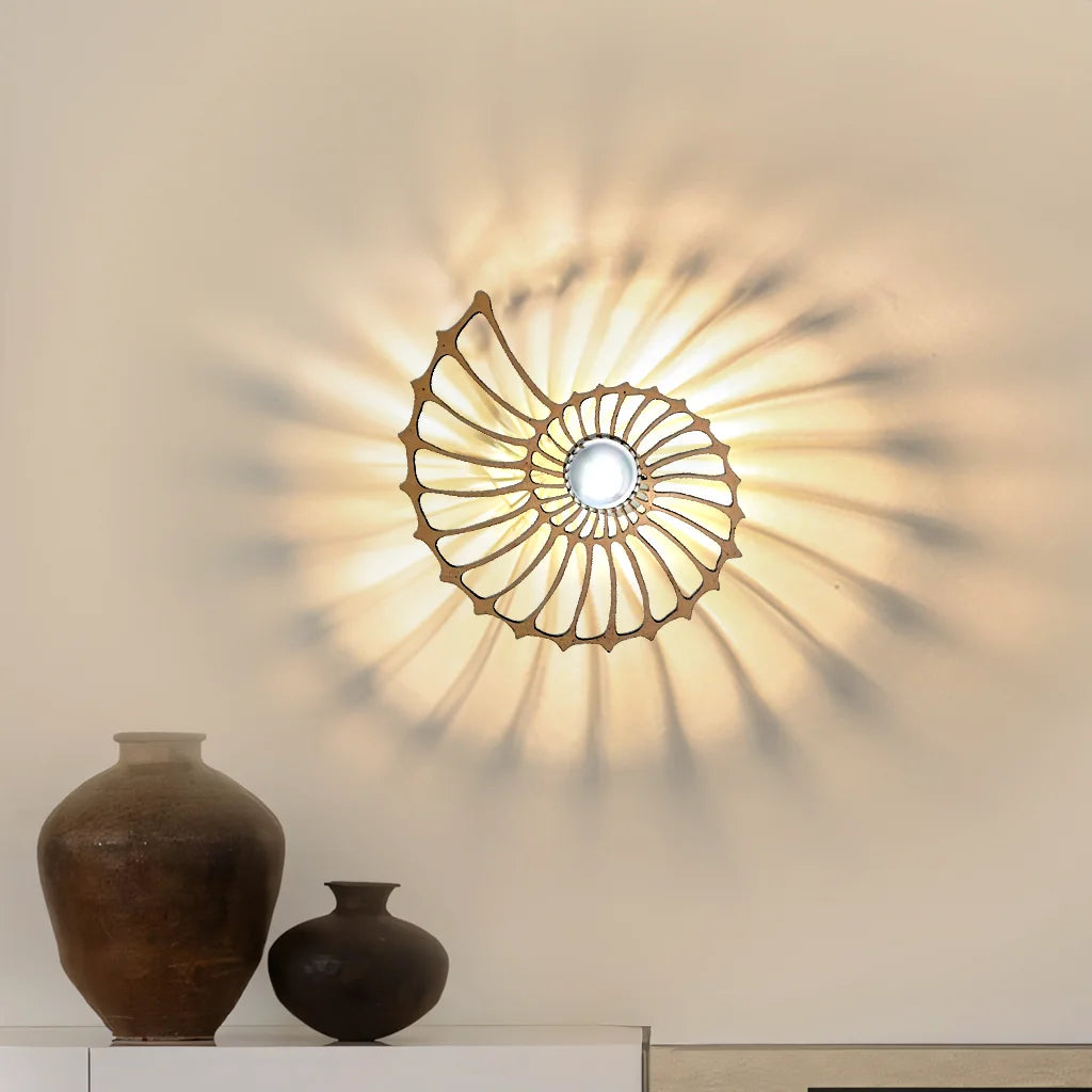 Medium gold geometric wall sconce casting a stunning 360-degree sunburst shadow pattern