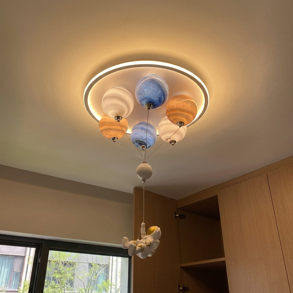 Meqzi astronaut planet ceiling light illuminated in a bright room with wooden cabinetry and window light