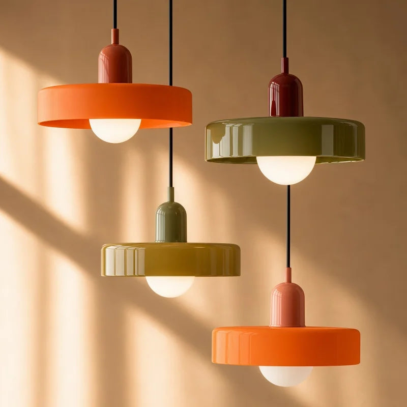Cluster of colourful Bauhaus mera pendant lights illuminating a warm, modern space