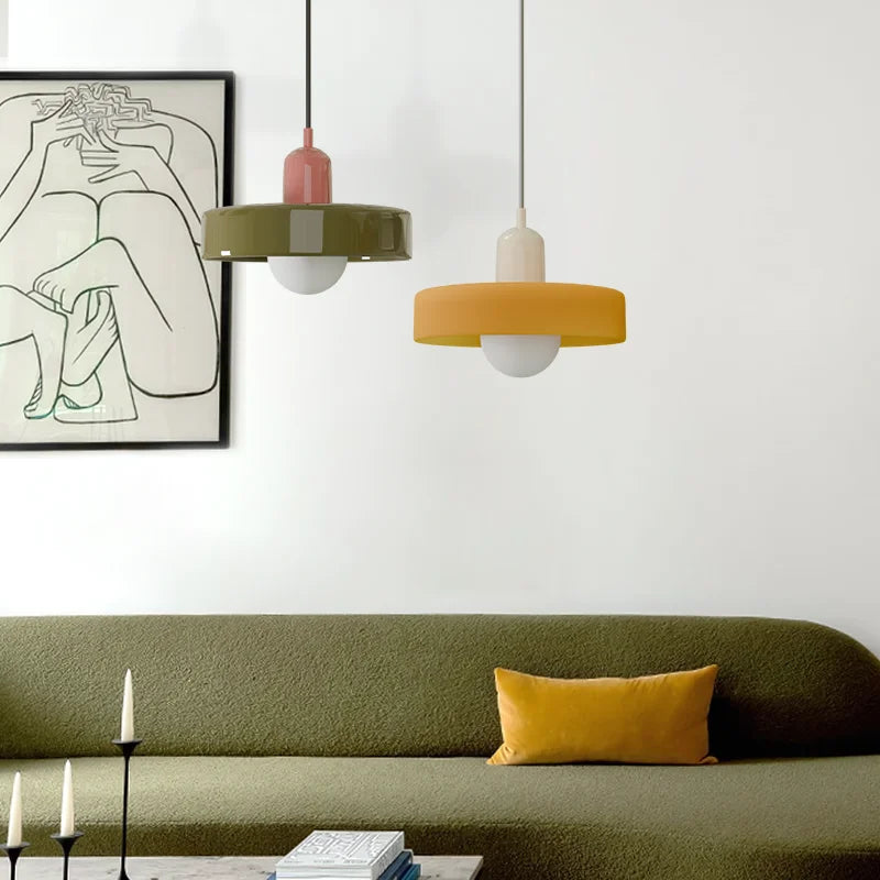 Two colourful Bauhaus mera pendant lights suspended in a stylish, contemporary green living room