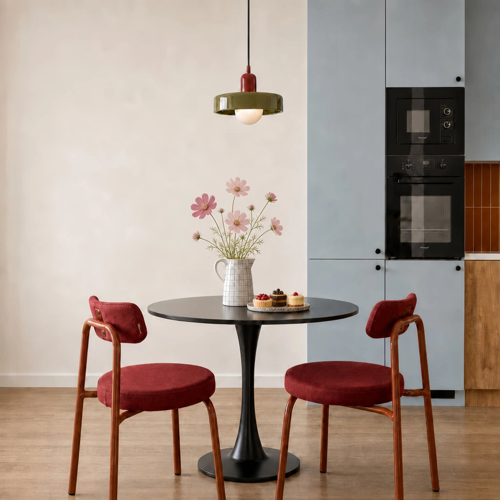 Green and red Bauhaus mera ceiling lamp illuminating a modern dining table with red chairs
