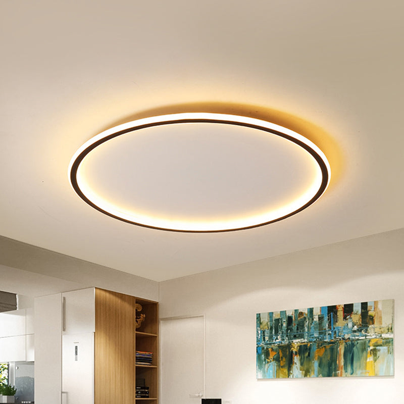 Modern merqi black halo ring LED flush mount ceiling light illuminating a contemporary living space