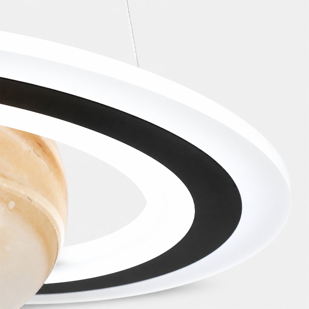 Close-up detail of Merven's illuminated LED ring and planet globe surface texture