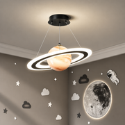 Merven Saturn ring planet pendant light glowing warm at night in a kids' space-themed bedroom with astronaut and moon wall decals