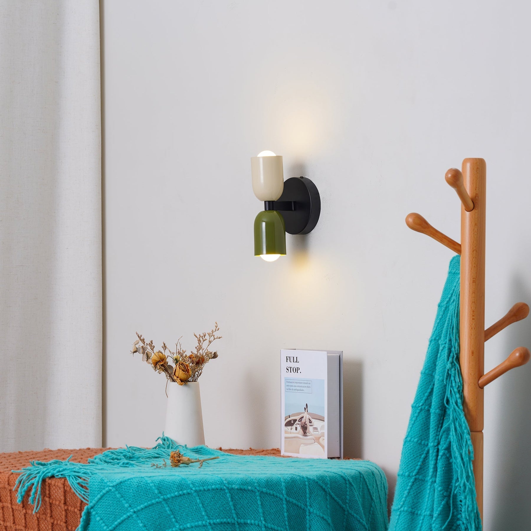 Mid-century double-head glass wall sconce illuminating a bright entryway and coat rack
