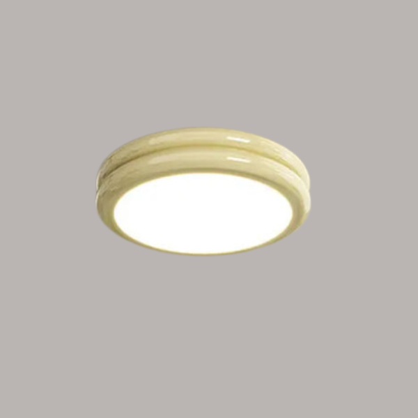 Milky yellow round LED flush mount fixture isolated against a neutral background