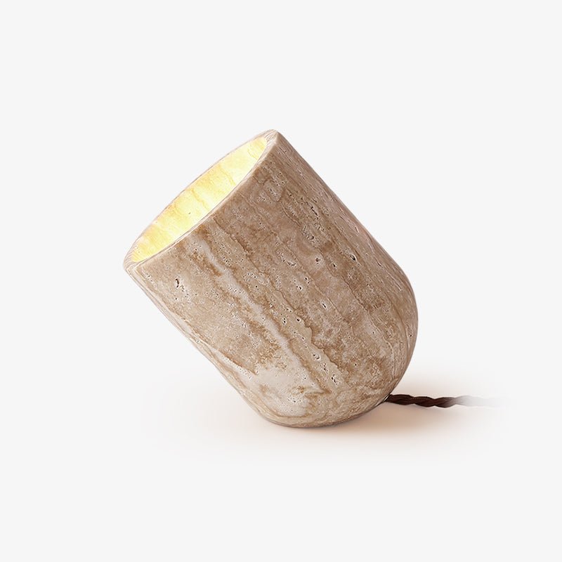 Tapered travertine stone misa desk lamp showing its natural porous texture, isolated on a white background
