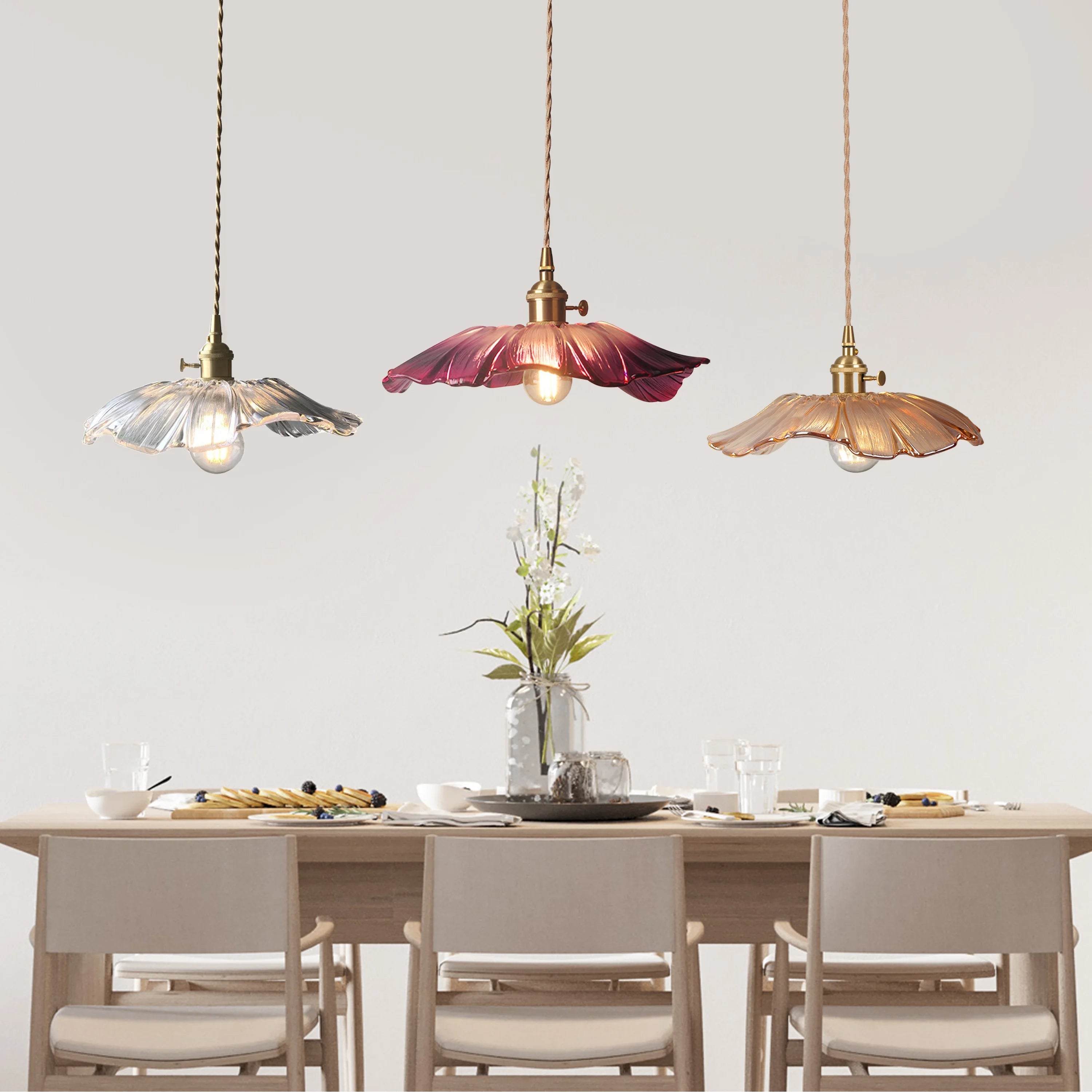 Mixed colour lotus glass pendant lights suspended elegantly over a modern dining table