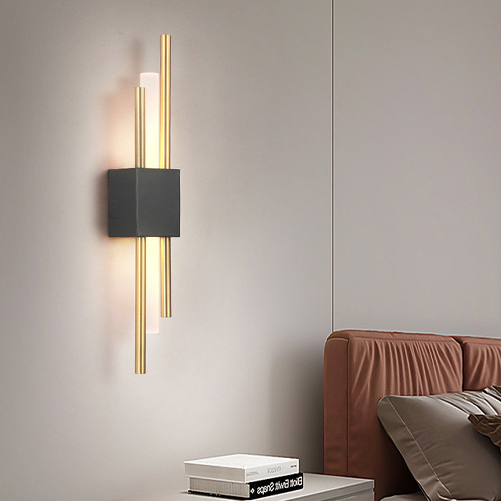 Modern black and gold two-tone wall sconce serving as a striking architectural accent in a lounge