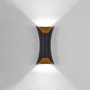 Modern black and gold hourglass LED outdoor wall light casting a sharp V-shaped beam