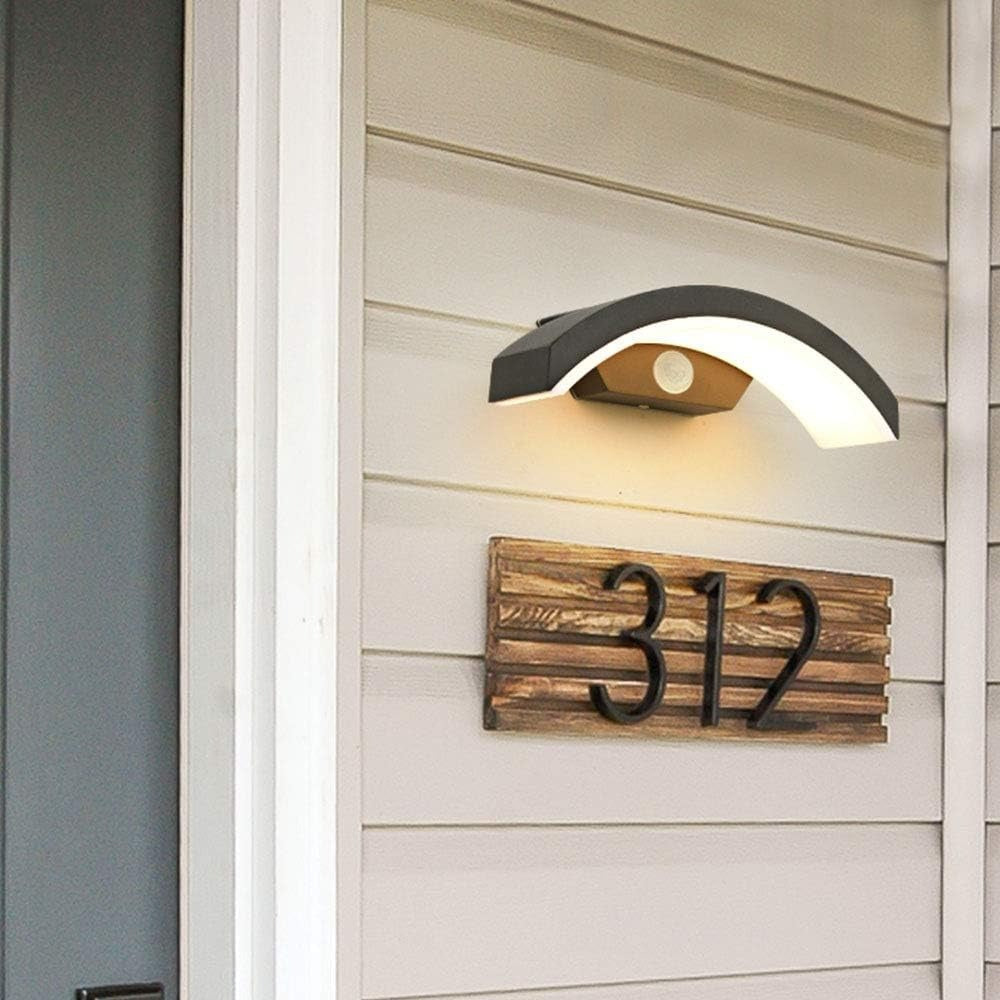 Modern outdoor wall light providing ambient illumination above a wooden house number plaque