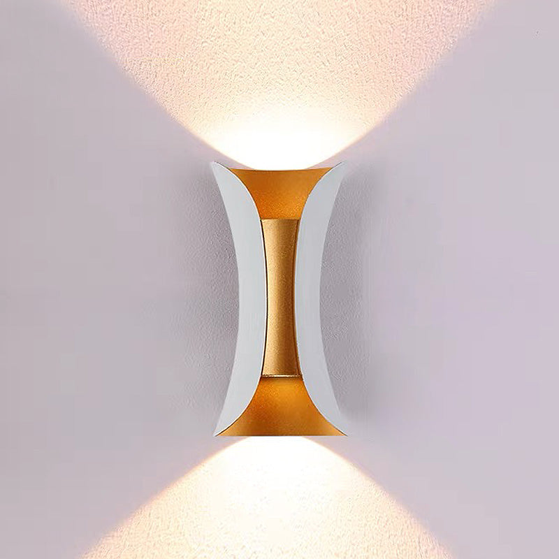 Modern white and gold exterior wall sconce casting a bright, symmetrical light beam