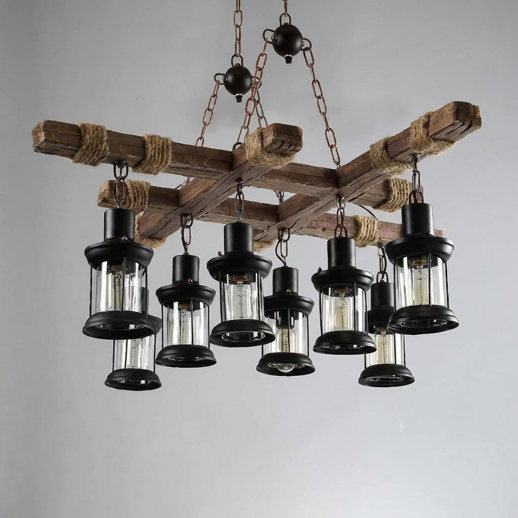 Mupzi industrial wood beam chandelier with black lantern pendant heads and ball-detail chain suspension on a grey studio background