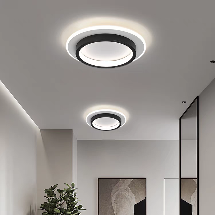Two modern black geometric halo LED flush mount mura ceiling lights illuminating a contemporary hallway