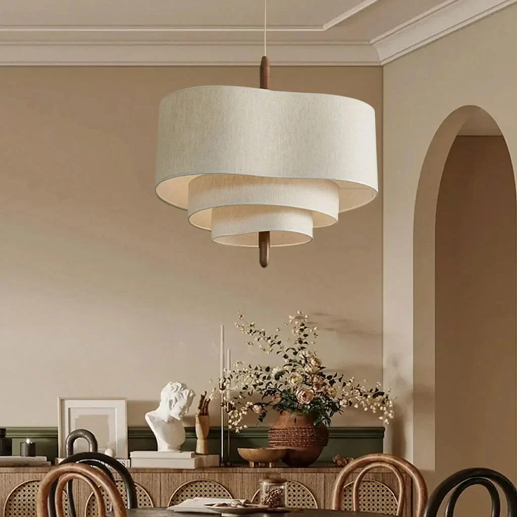 Wabi-Sabi tiered myska linen pendant light illuminating a dining table in a serene room with arched architecture