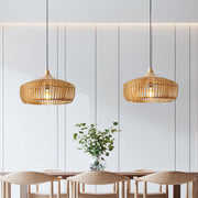 Pair of natural wood Japandi slatted pendant lights suspended over a modern dining table