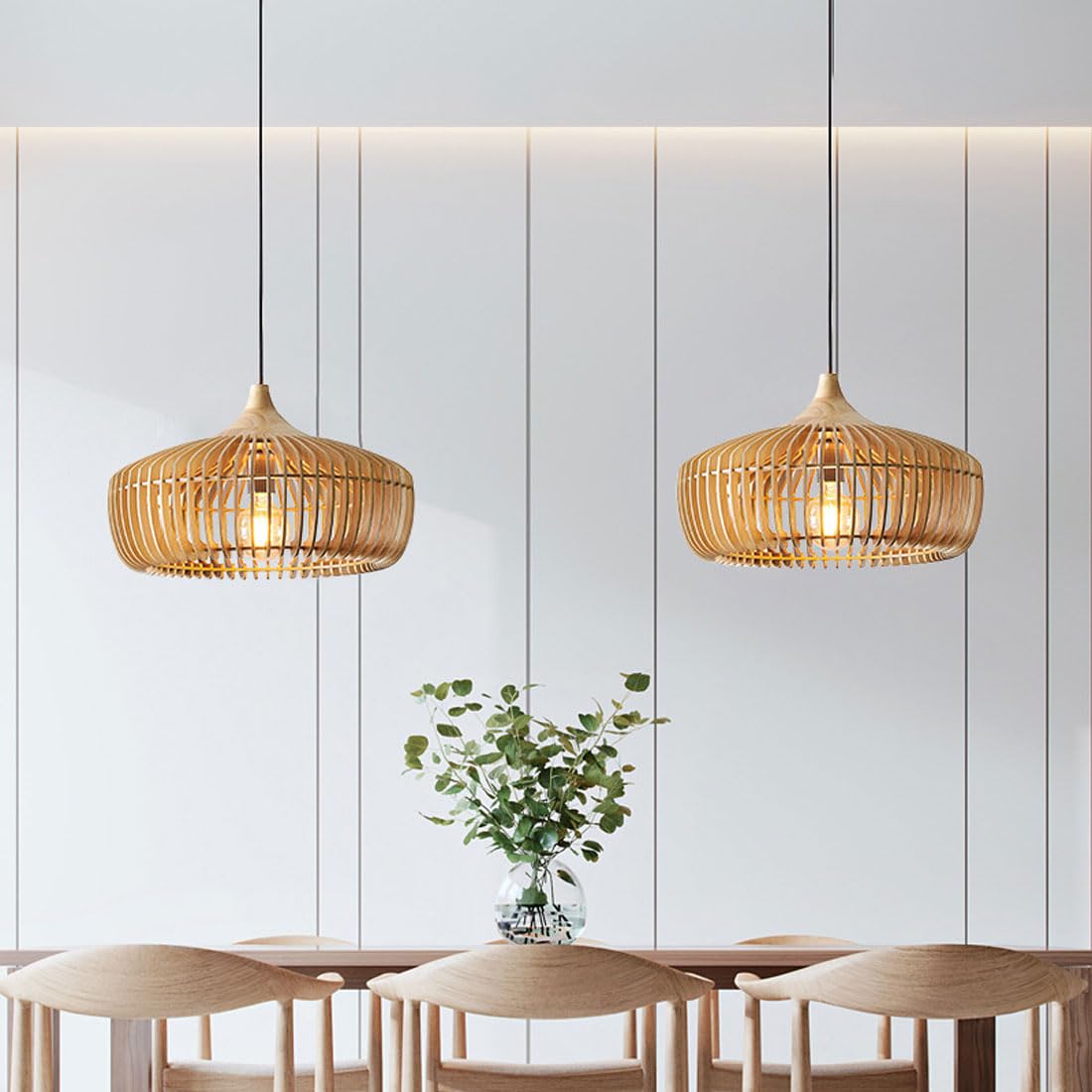 Pair of natural wood Japandi slatted pendant lights suspended over a modern dining table