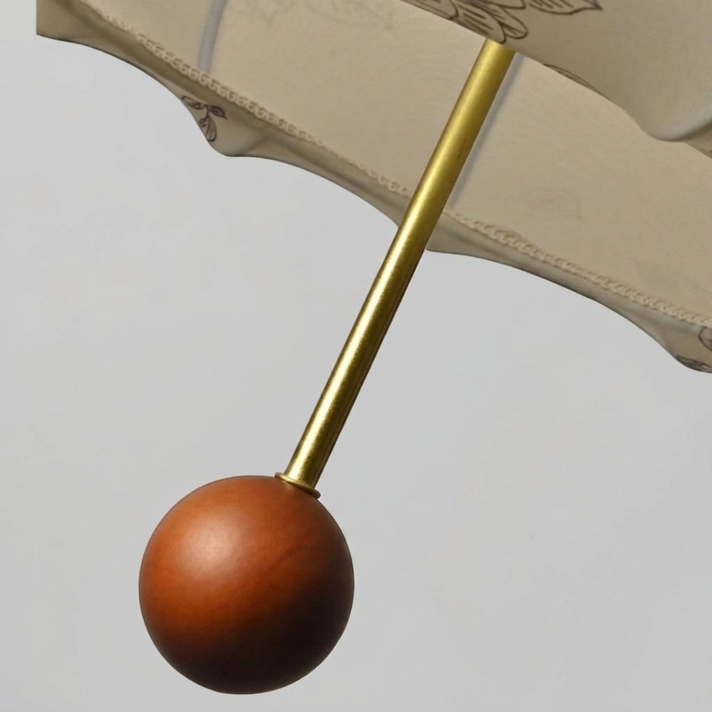 Close-up of Naxlu's wood ball pull on gold-finished iron rod