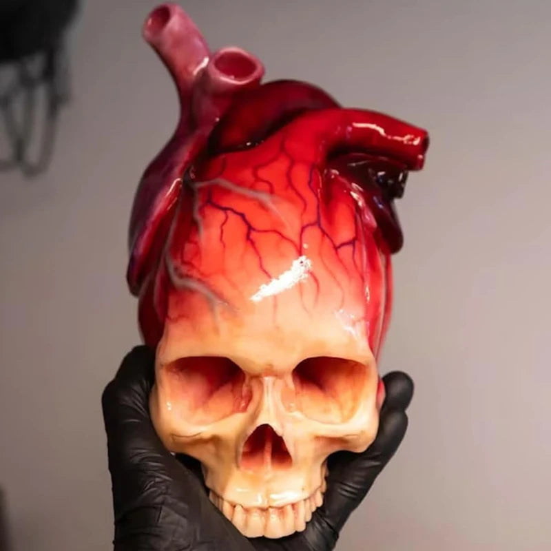 Necrovalve anatomical heart and skull resin ornament held in hand showing scale