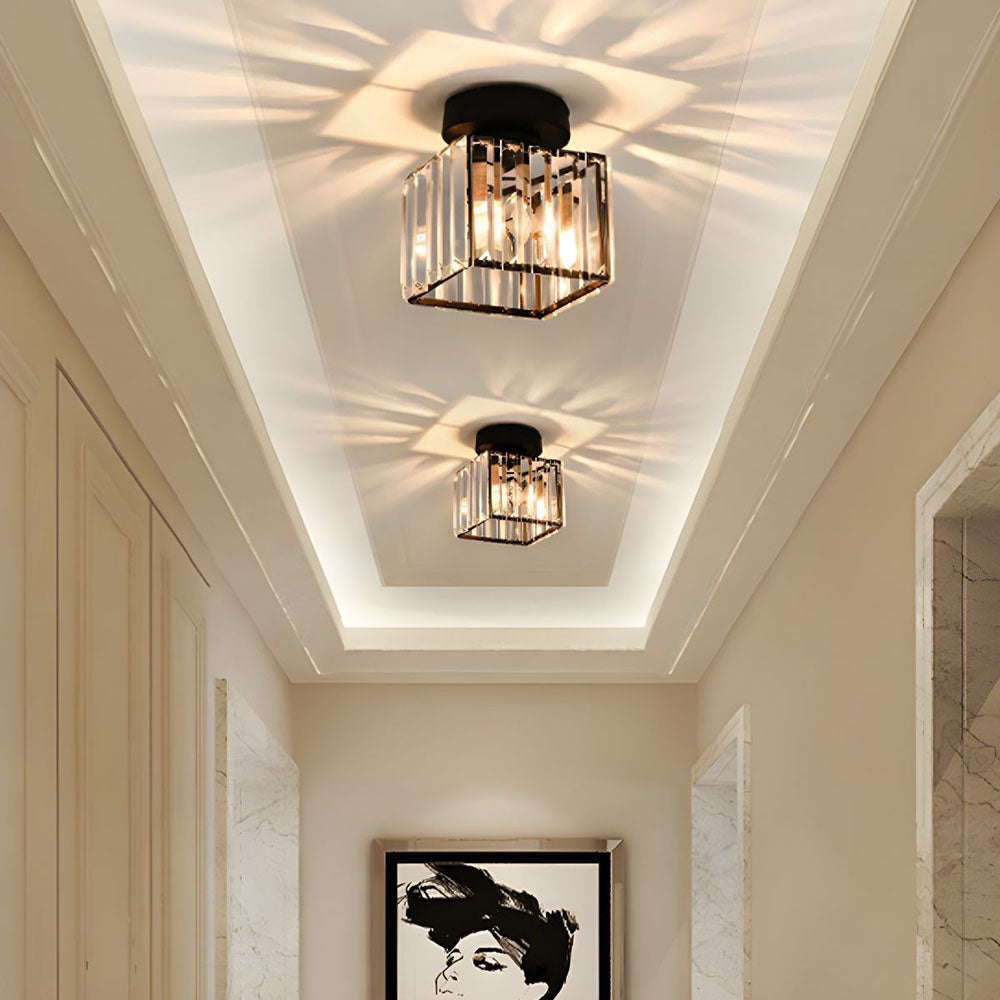 Two modern black square crystal prism flush mount netyf ceiling lights illuminating a bright hallway with a starburst pattern