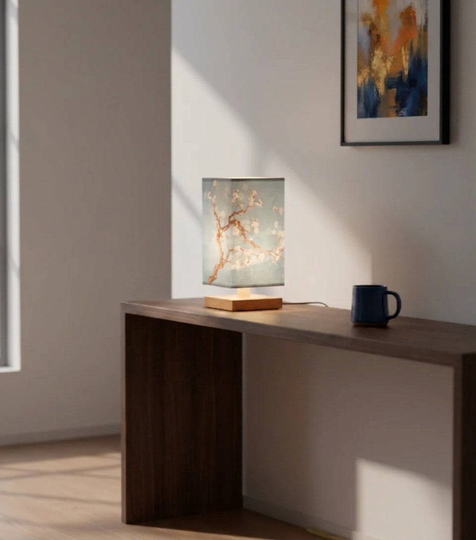 Nimza Blue Blossom table lamp on a desk beside a window