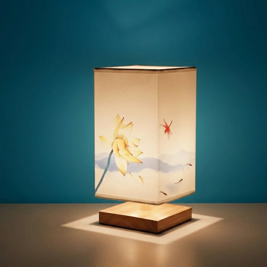 Nimza Lotus Blossom table lamp with yellow lotus fabric shade on a teal background