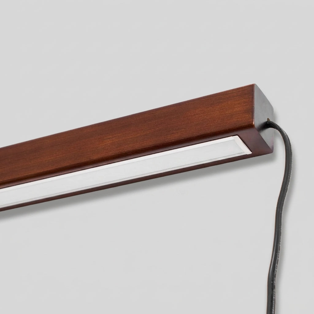 Close-up of the Nizku Walnut linear wall lamp's corner and cable connection