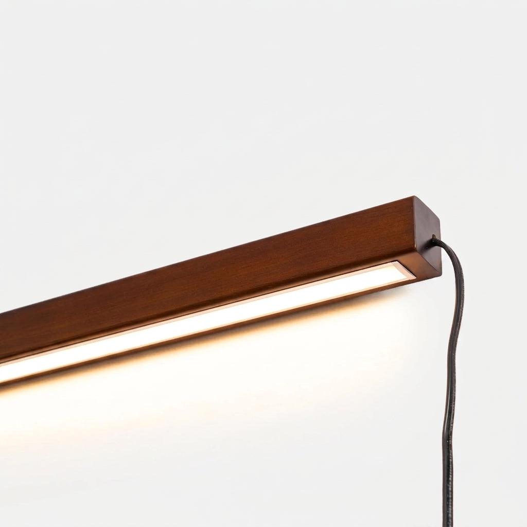 Close-up of the Nizku Walnut linear wall lamp's LED edge and light strip