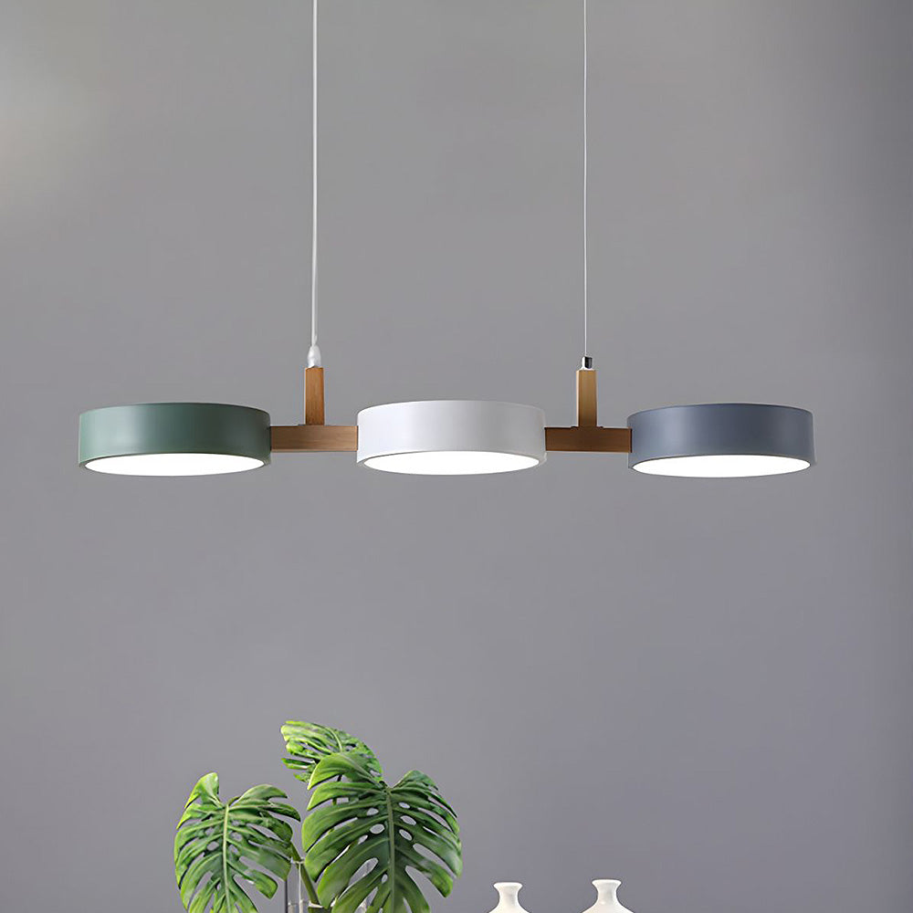 Modern white, grey, and green 3-light Nordic nohit linear pendant suspended over a sleek dining table