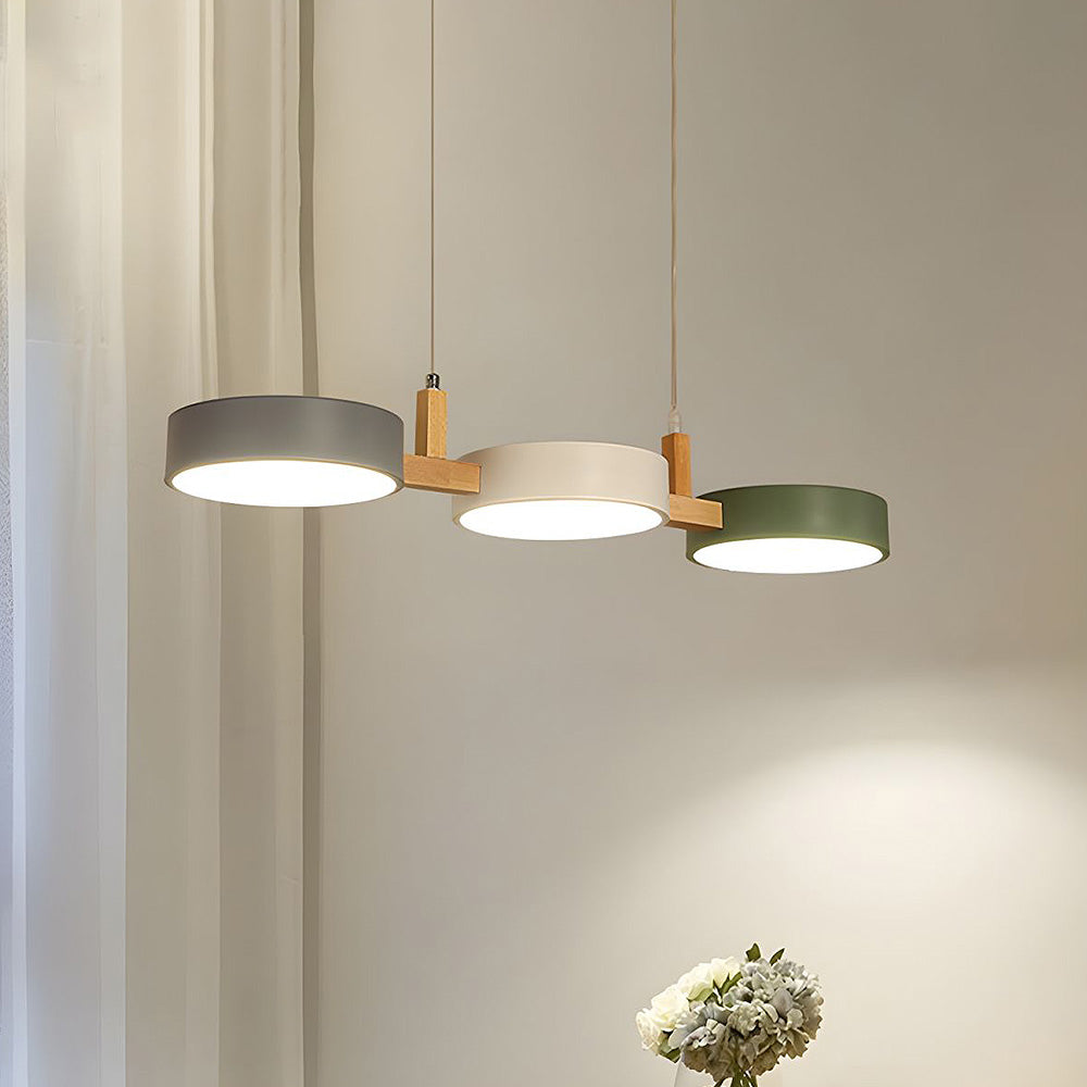 White, grey, and green 3-light nohit pendant illuminating a contemporary dining room setup