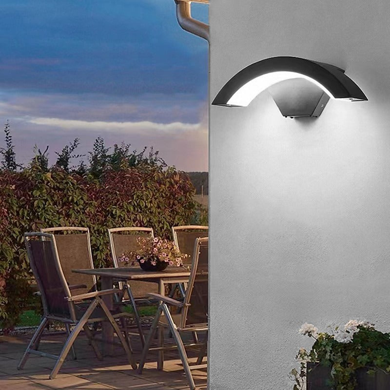 Arched LED wall lighting illuminating an outdoor patio and dining area at twilight
