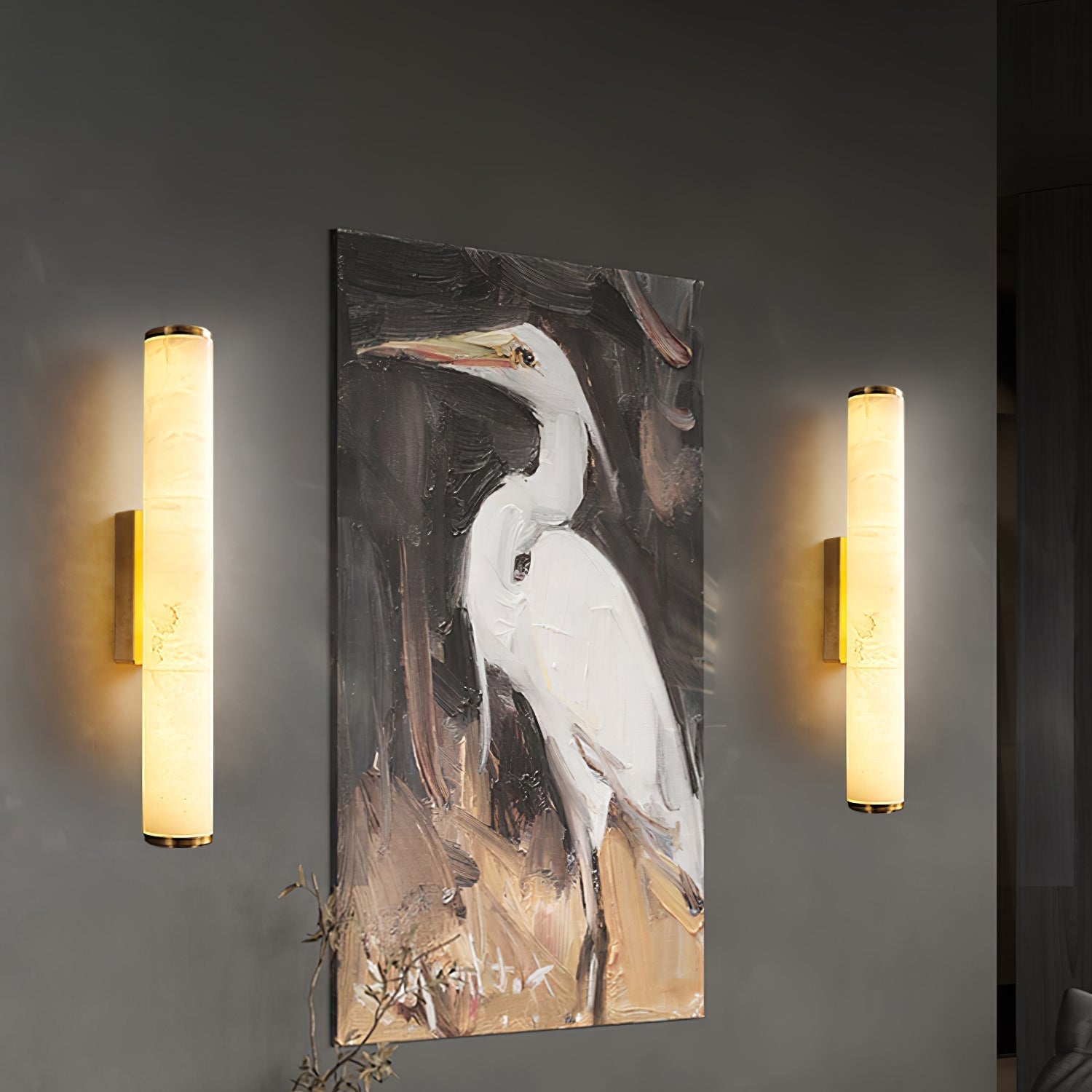 Pair of modern alabaster wall sconces beautifully framing a piece of artwork on a living room wall