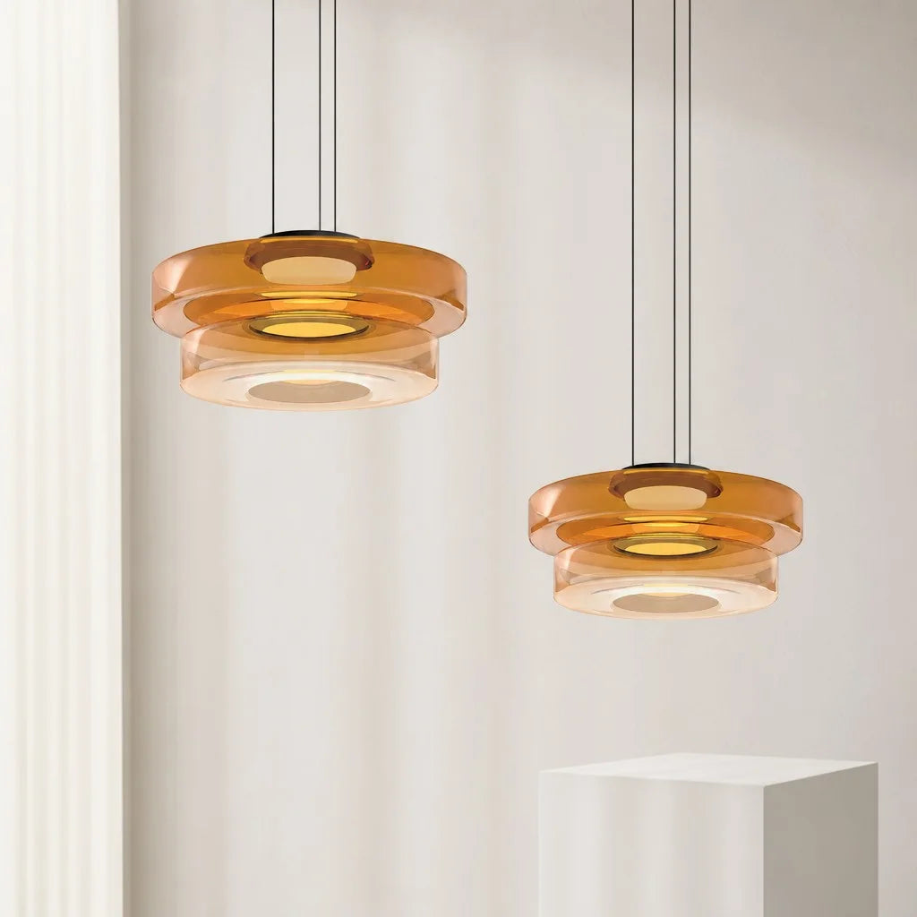 Pair of 2-layer amber glass pendants suspended at varying heights for a layered modern look