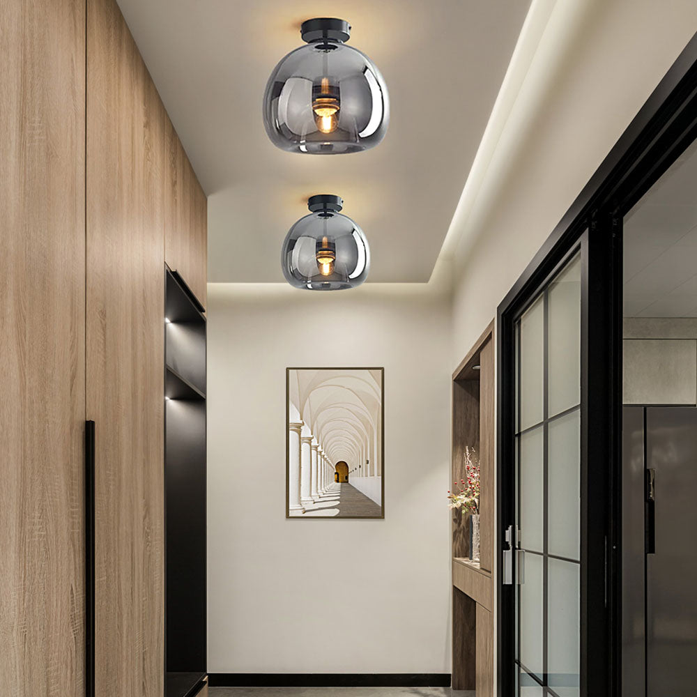 Pair of compact smoke grey tinted glass pawo ceiling lights installed in a modern hallway
