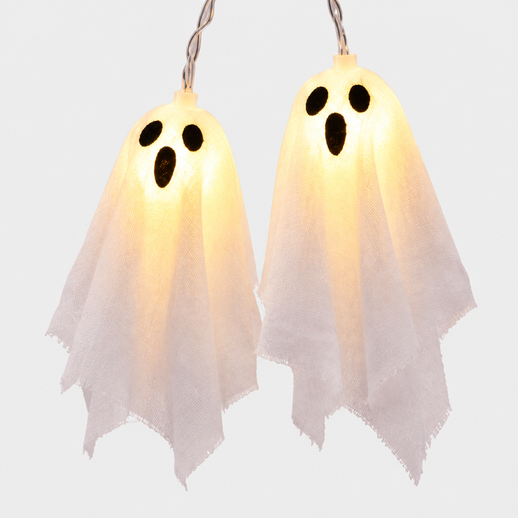 Close-up of two Phantasm LED ghost string light covers showing printed face detail