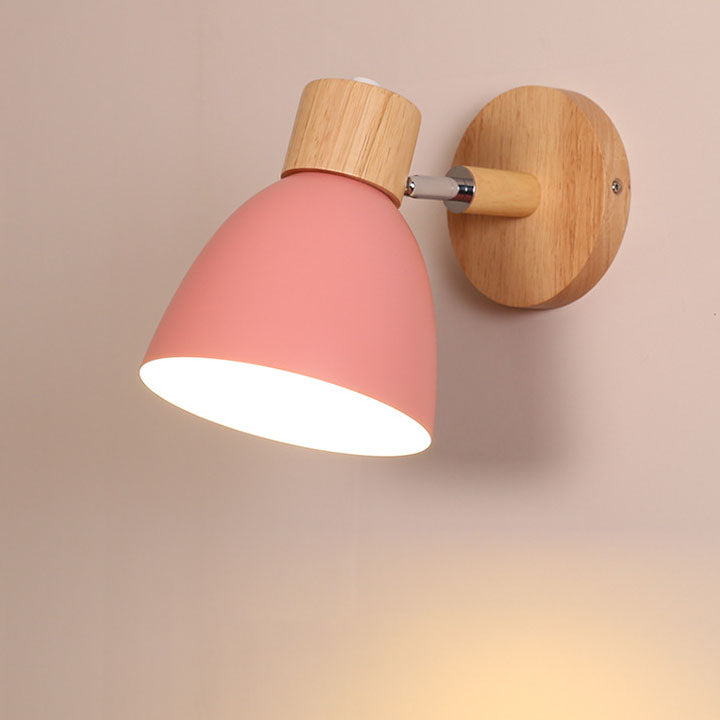 Pink macaron bedroom sconce highlighting its smooth metal shade and natural wooden bracket