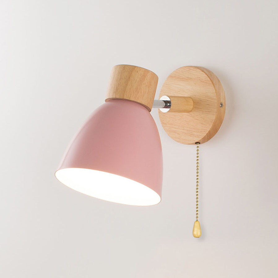 Soft pink Nordic wood wall lamp featuring an adjustable head and pull cord