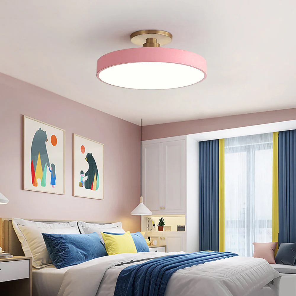 Pink pastel drum ceiling lamp adding a playful pop of colour to a bright, modern bedroom
