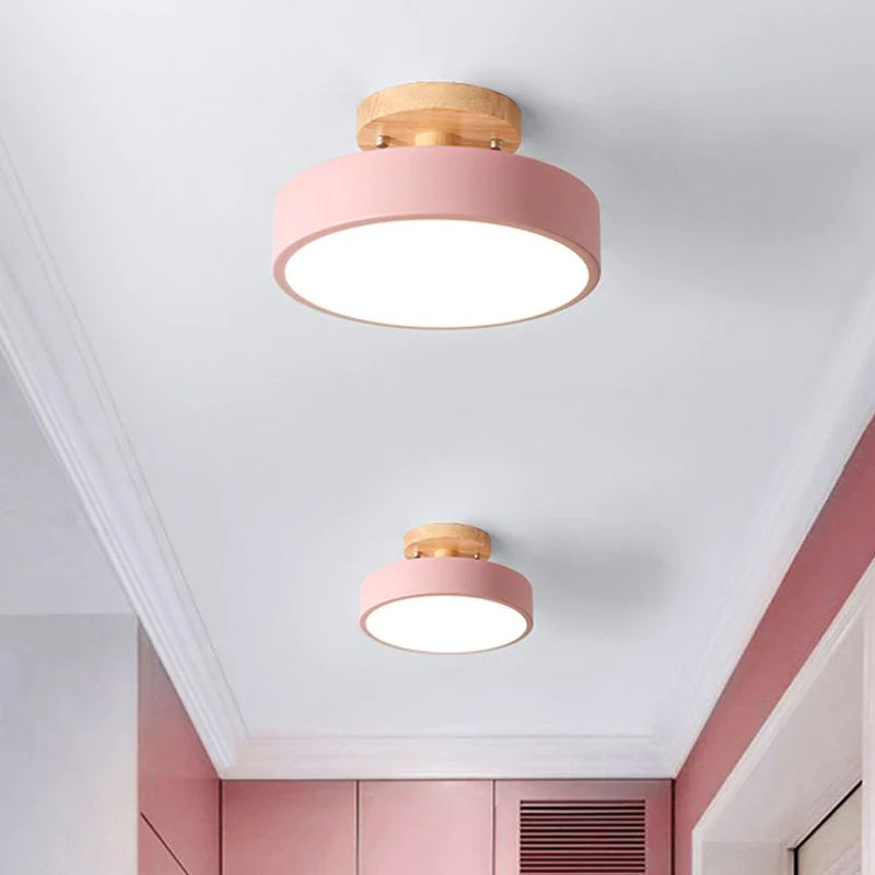 Pair of soft pink pastel macaron ceiling lights adding a playful touch to a bright hallway